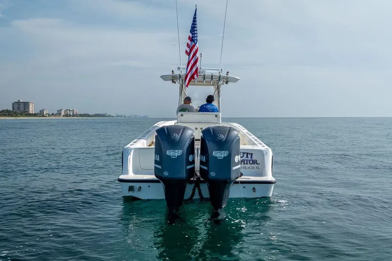 Slide: The Image of 2014 SeaVee 34 boat with dual Yamaha engines on calm ocean waters. - 10