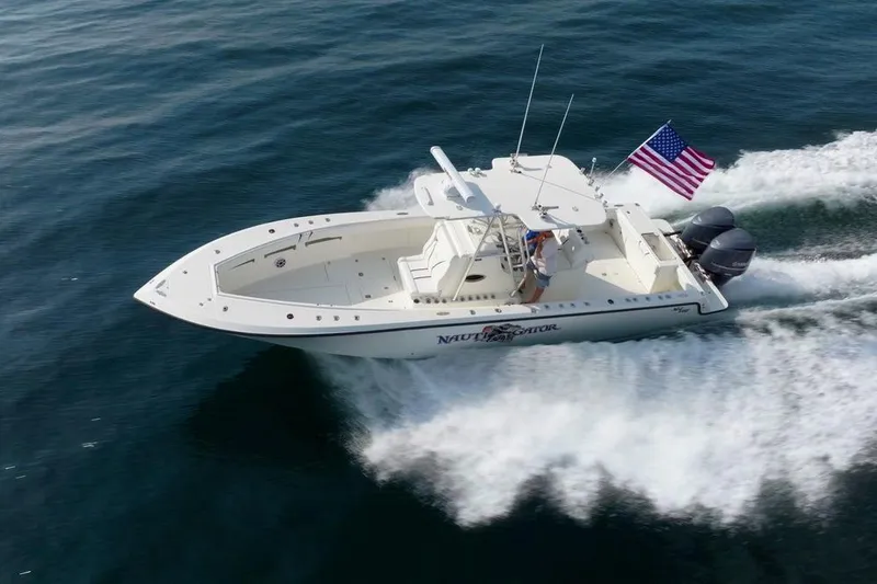 Slide: The Image of 2014 SeaVee 34 boat cruising on open water with American flag. - 15