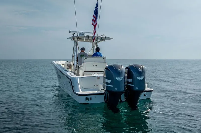 Slide: The Image of 2014 SeaVee 34 boat with dual Yamaha engines on open water. - 2