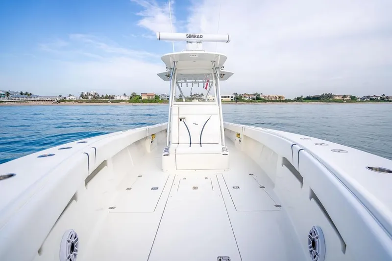 Slide: The Image of 2014 SeaVee 34 boat on calm water, featuring spacious deck and modern design. - 23