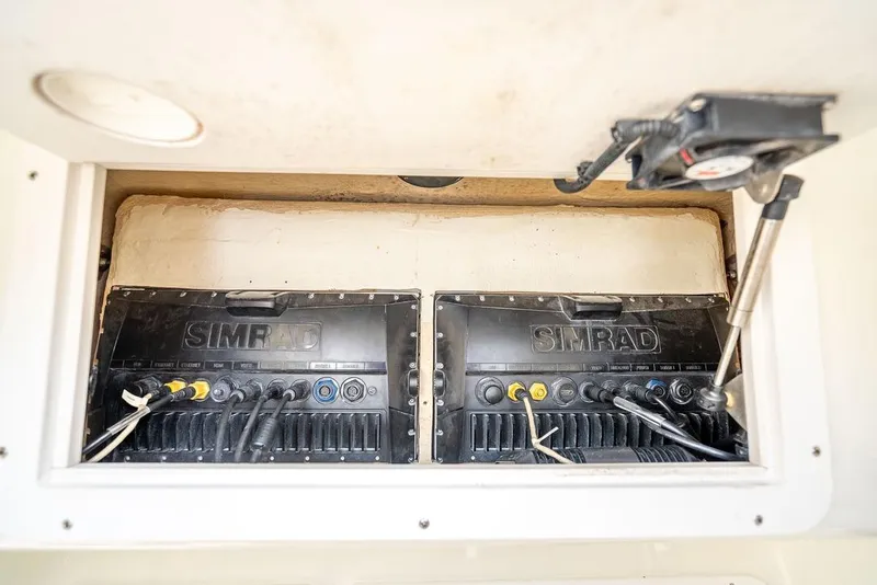 Slide: The Image of Simrad electronics in 2014 SeaVee 34 boat compartment, showcasing wiring and installation. - 29