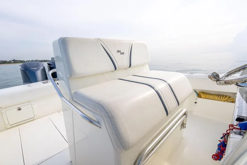 Slide: The Image of 2014 SeaVee 34 boat interior with white seating and ocean view. - 35
