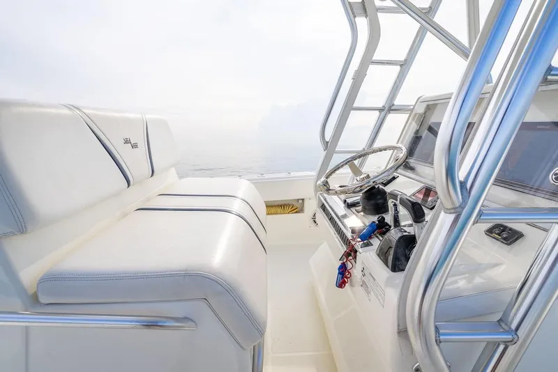 Slide: The Image of 2014 SeaVee 34 boat interior with steering wheel and seating, showcasing sleek design. - 36