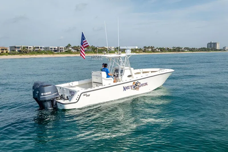 Slide: The Image of 2014 SeaVee 34 boat with Yamaha engines cruising near the coast. - 4