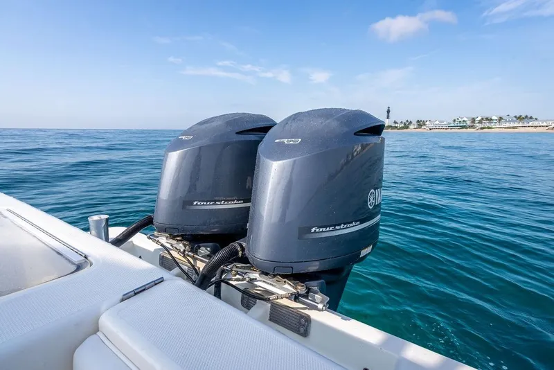 Slide: The Image of 2014 SeaVee 34 boat with dual outboard motors on calm ocean waters. - 46