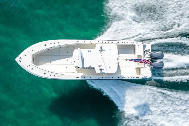 Slide: The Image of Overhead view of 2014 SeaVee 34 boat cruising on turquoise water. - 5