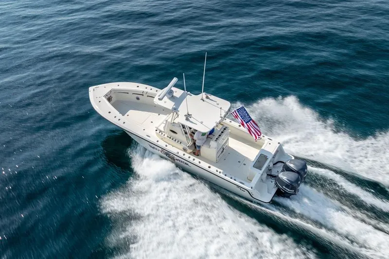 Slide: The Image of 2014 SeaVee 34 boat cruising on open water with American flag. - 7