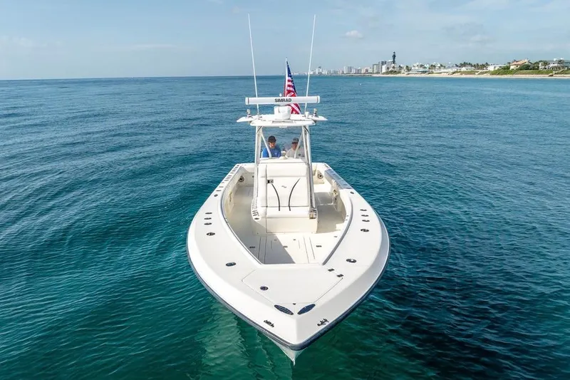 Slide: The Image of 2014 SeaVee 34 boat cruising on clear blue ocean near coastline. - 8