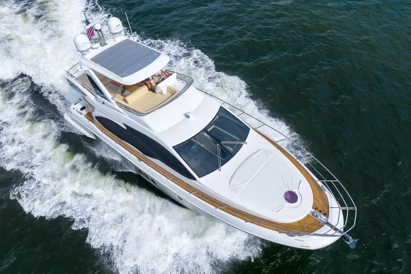 Slide: The Image of 2014 Azimut 54 Flybridge yacht cruising on open water, aerial view. - 11