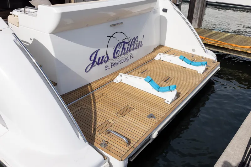 Slide: The Image of 2014 Azimut 54 Flybridge yacht stern with wooden deck, docked in St. Petersburg, FL. - 16