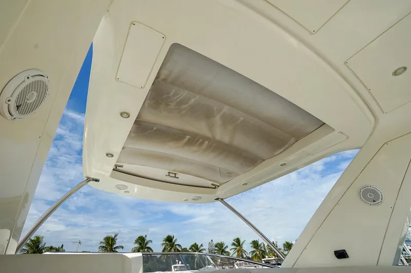 Slide: The Image of 2014 Azimut 54 Flybridge yacht ceiling with speakers, under a clear blue sky. - 28