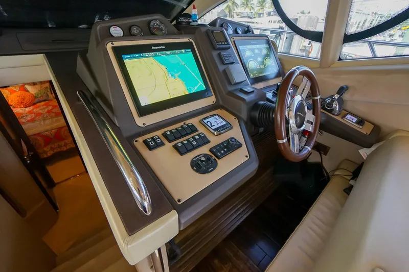Slide: The Image of 2014 Azimut 54 Flybridge helm with navigation screens and controls. - 35