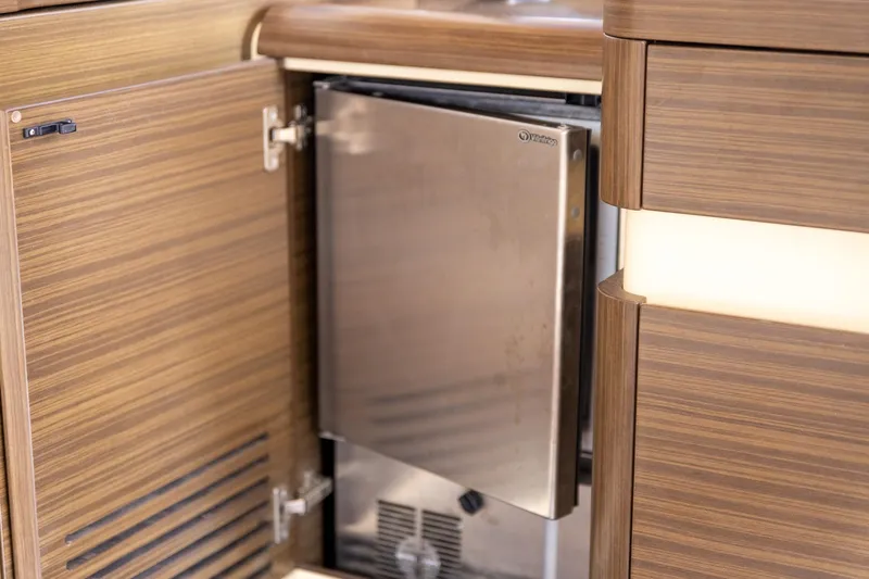 Slide: The Image of 2014 Azimut 54 Flybridge yacht interior with open stainless steel fridge. - 47