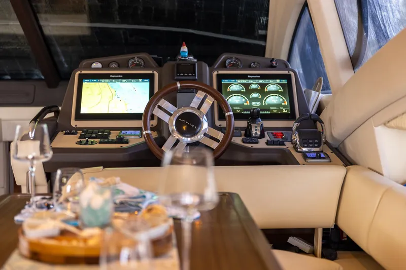Slide: The Image of Luxurious 2014 Azimut 54 Flybridge yacht cockpit with modern navigation displays and elegant dining setup. - 51