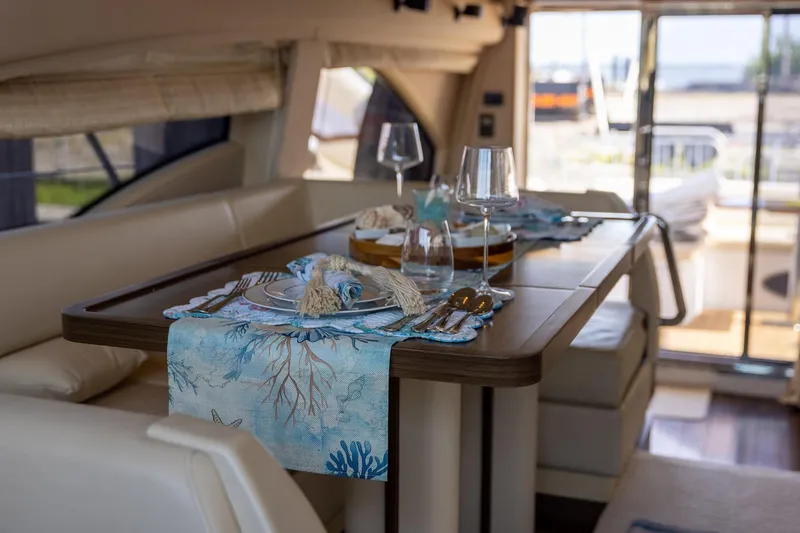 Slide: The Image of Luxurious dining area on 2014 Azimut 54 Flybridge yacht, elegantly set table with ocean-themed decor. - 58