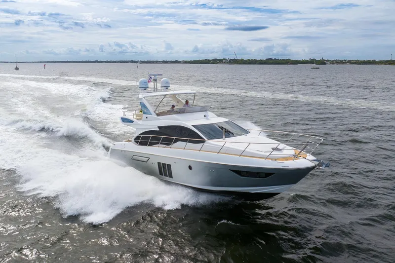 Slide: The Image of 2014 Azimut 54 Flybridge yacht cruising on open water. - 6