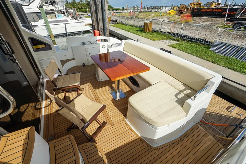 Slide: The Image of Luxurious 2014 Azimut 54 Flybridge yacht deck with seating and table. - 64