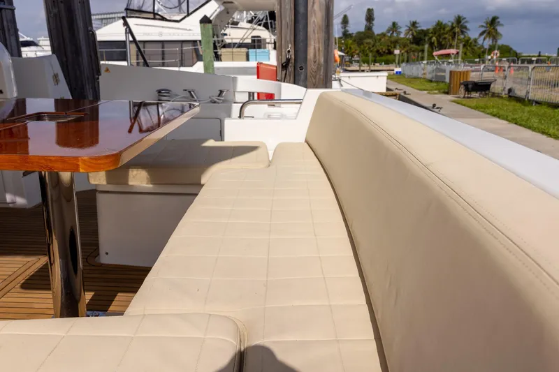 Slide: The Image of Luxurious seating area on 2014 Azimut 54 Flybridge yacht with polished wooden table. - 66