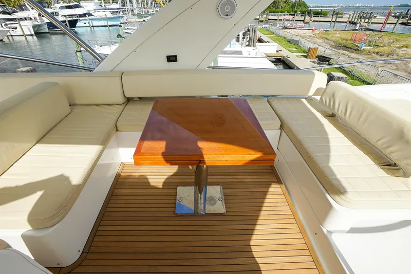 Slide: The Image of Luxurious seating area on 2014 Azimut 54 Flybridge yacht with wooden table. - 67