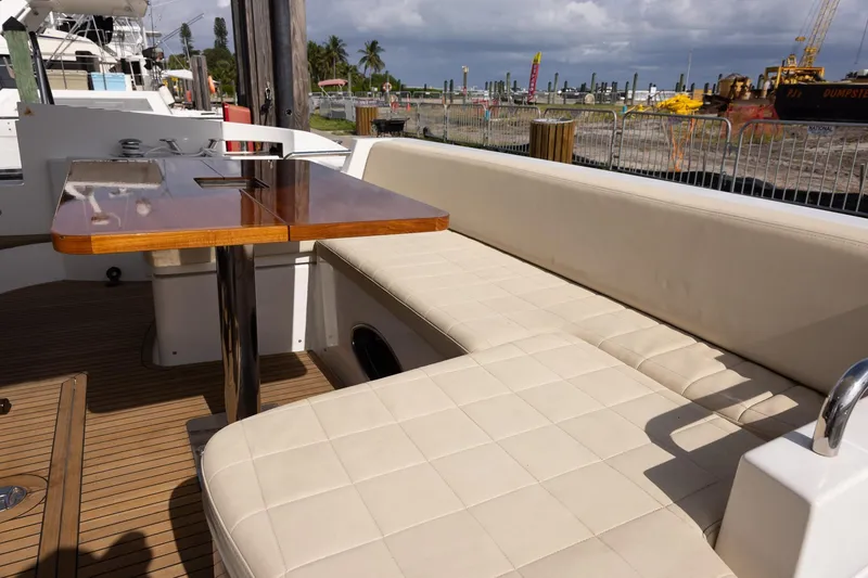 Slide: The Image of Luxurious seating area on 2014 Azimut 54 Flybridge yacht with wooden table. - 69