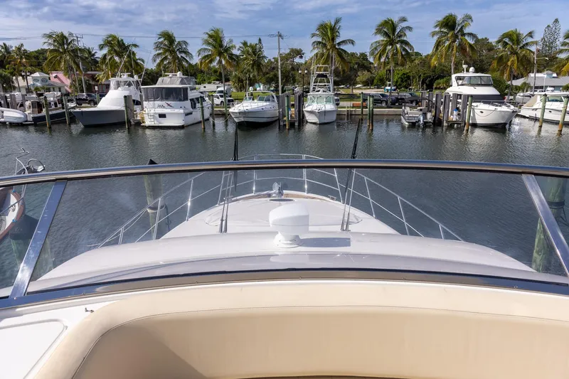 Slide: The Image of View from Azimut 54 Flybridge yacht, 2014 model, overlooking marina with palm trees and boats. - 76