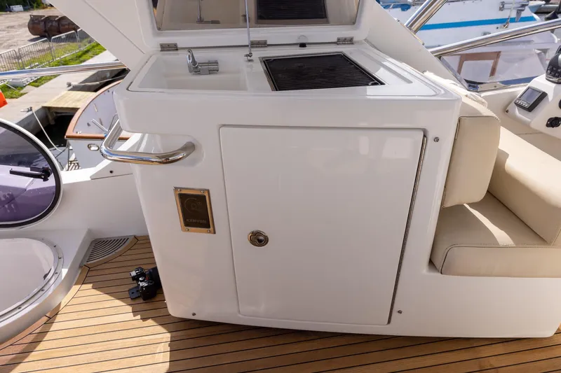 Slide: The Image of 2014 Azimut 54 Flybridge yacht with outdoor kitchenette and seating area. - 78