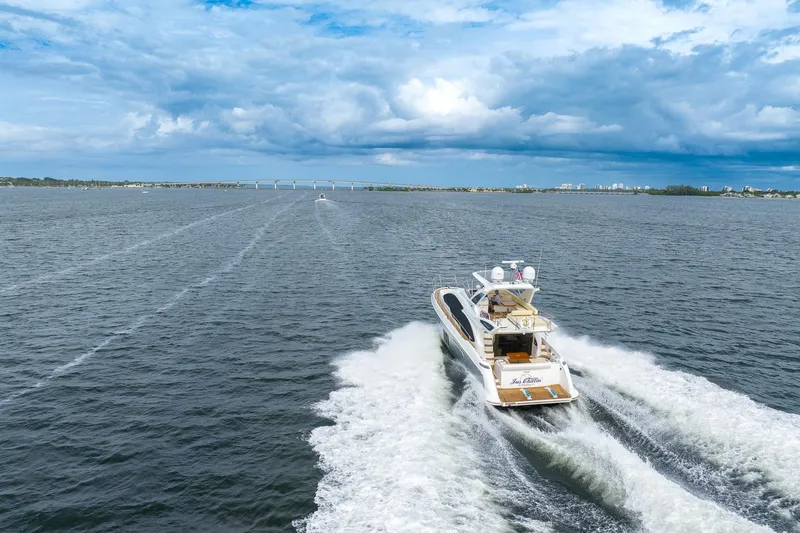 Slide: The Image of Azimut 54 Flybridge 2014 yacht cruising on open water under a cloudy sky. - 8