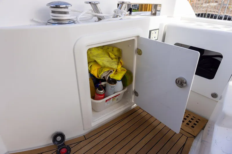 Slide: The Image of Open storage compartment on 2014 Azimut 54 Flybridge yacht with cleaning supplies. - 82