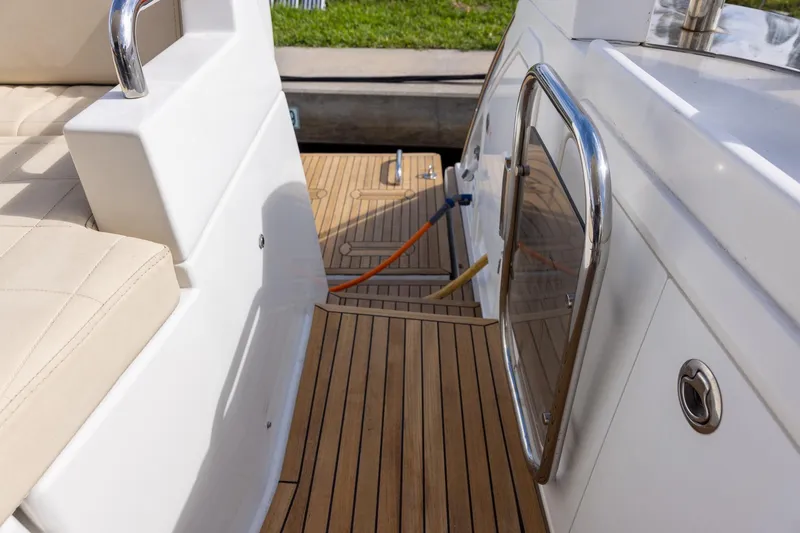Slide: The Image of 2014 Azimut 54 Flybridge yacht deck with teak flooring and stainless steel railing. - 95