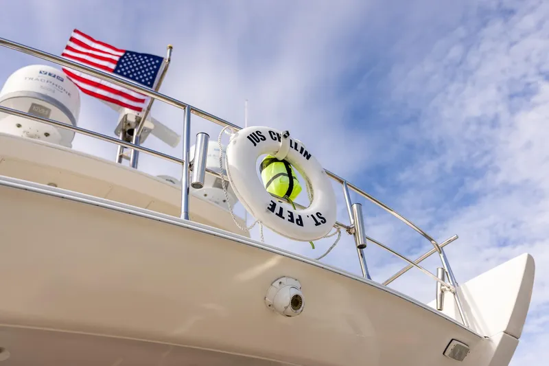 Slide: The Image of Azimut 54 Flybridge 2014 yacht with American flag and life preserver against blue sky. - 97