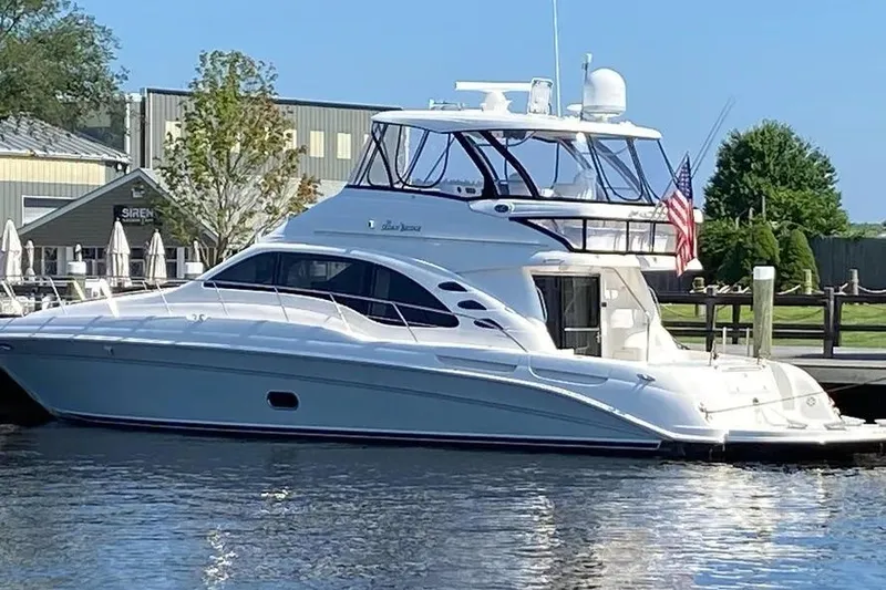 The Image of 2006 Sea Ray 580 Sedan Bridge yacht docked at marina, sunny day. - 1