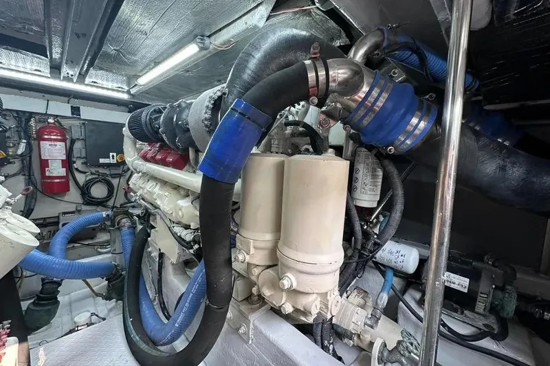Slide: The Image of Engine room of 2006 Sea Ray 580 Sedan Bridge with visible hoses and components. - 11
