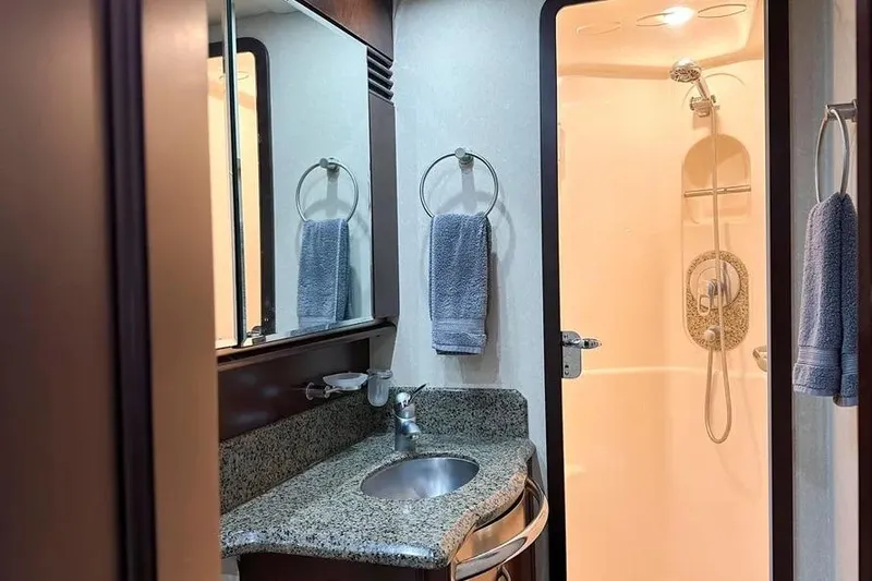 Slide: The Image of Luxurious bathroom in 2006 Sea Ray 580 Sedan Bridge yacht with granite countertop and shower. - 14