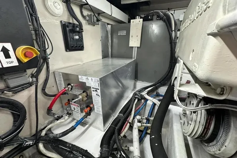 Slide: The Image of Engine room of 2006 Sea Ray 580 Sedan Bridge with mechanical components and wiring. - 17