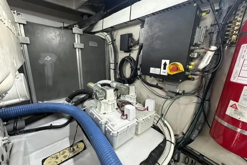 Slide: The Image of Engine room of 2006 Sea Ray 580 Sedan Bridge with mechanical components and fire extinguisher. - 18
