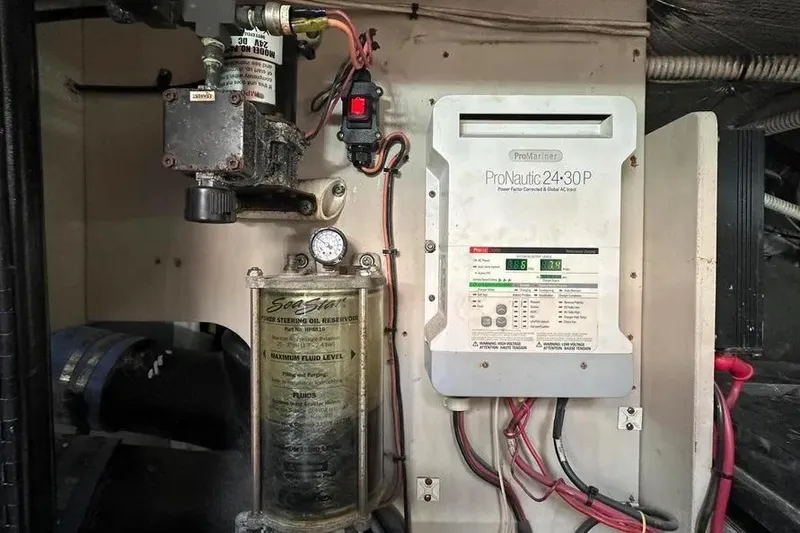 Slide: The Image of Engine room of 2006 Sea Ray 580 Sedan Bridge with ProNautic charger and steering oil reservoir. - 21