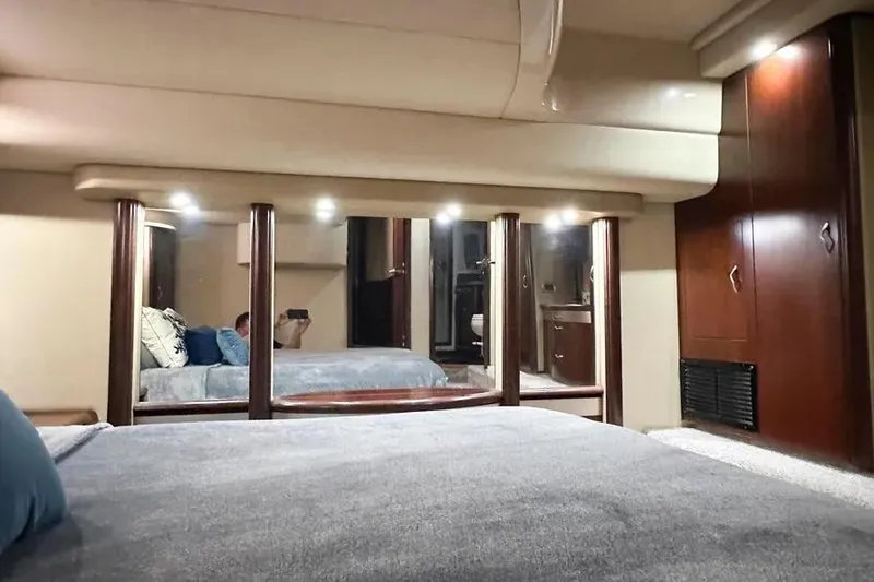 Slide: The Image of Luxurious 2006 Sea Ray 580 Sedan Bridge yacht interior with cozy bedroom and elegant wood finishes. - 25