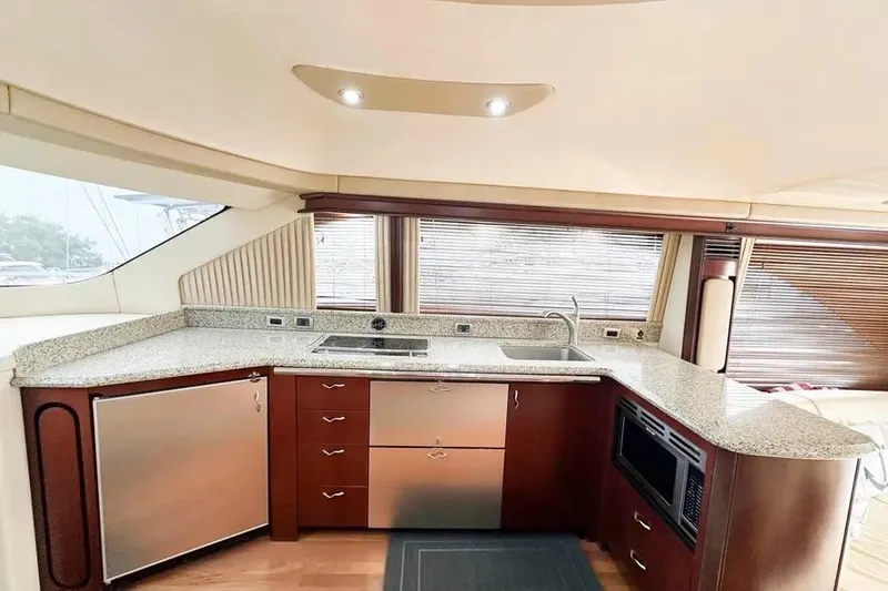 Slide: The Image of Luxurious kitchen interior of 2006 Sea Ray 580 Sedan Bridge yacht with modern appliances. - 28