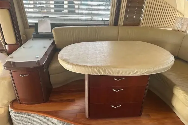 Slide: The Image of Interior of 2006 Sea Ray 580 Sedan Bridge with elegant dining area and wooden cabinetry. - 30