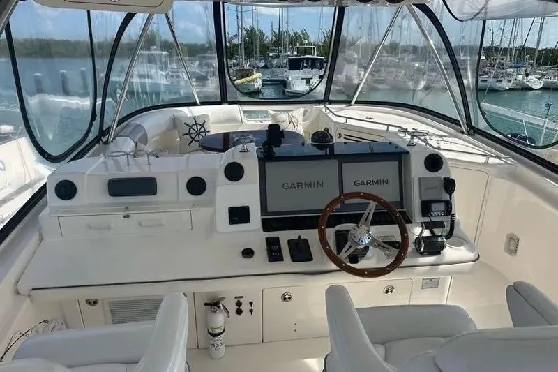 Slide: The Image of 2006 Sea Ray 580 Sedan Bridge helm with Garmin navigation, docked in a marina. - 33