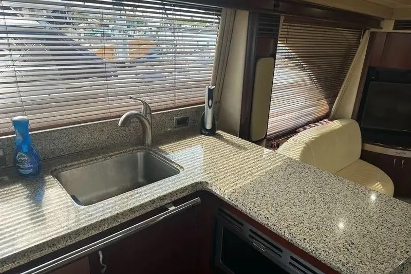 Slide: The Image of Luxurious 2006 Sea Ray 580 Sedan Bridge yacht interior with granite countertops and modern amenities. - 39