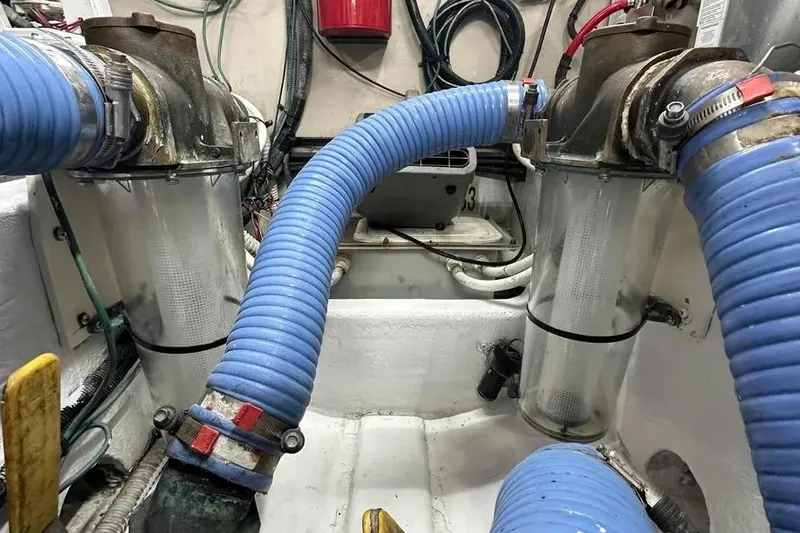 Slide: The Image of Engine room of 2006 Sea Ray 580 Sedan Bridge with blue hoses and filters. - 41