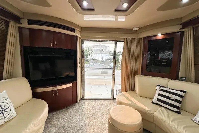 Slide: The Image of Luxurious interior of 2006 Sea Ray 580 Sedan Bridge yacht with plush seating and entertainment system. - 43