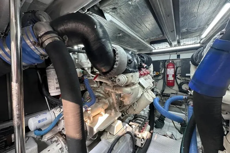 Slide: The Image of Engine room of 2006 Sea Ray 580 Sedan Bridge with visible hoses and equipment. - 5