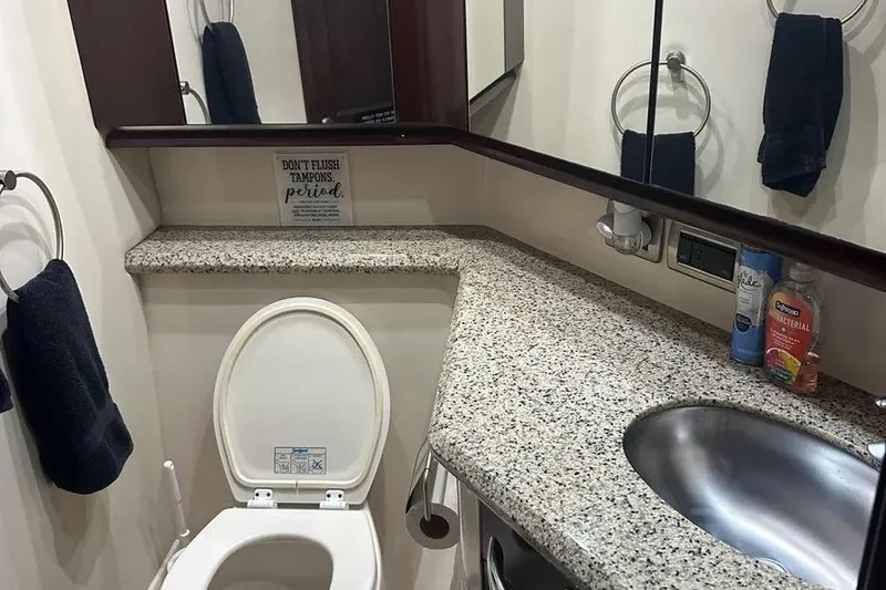 Slide: The Image of Bathroom interior of 2006 Sea Ray 580 Sedan Bridge with granite countertop and stainless steel sink. - 54