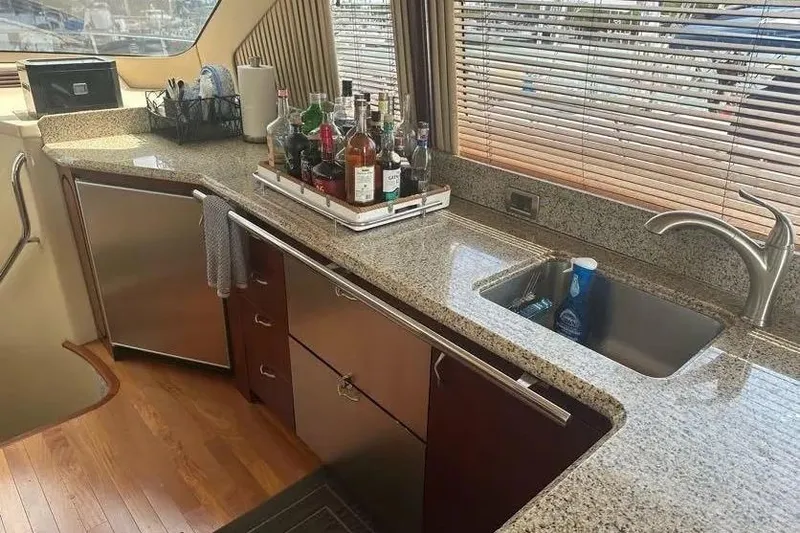 Slide: The Image of Luxurious kitchen area in a 2006 Sea Ray 580 Sedan Bridge yacht with granite countertops. - 6