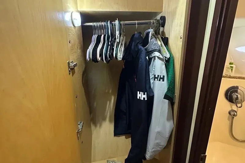 Slide: The Image of Closet with jackets and hangers inside a 2006 Sea Ray 580 Sedan Bridge yacht. - 65