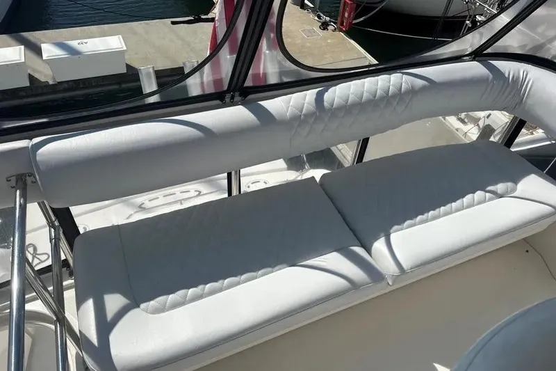 Slide: The Image of 2006 Sea Ray 580 Sedan Bridge yacht with white cushioned seating on deck. - 67