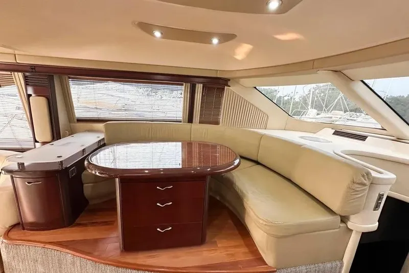 Slide: The Image of Luxurious interior of 2006 Sea Ray 580 Sedan Bridge yacht with elegant seating and table. - 9
