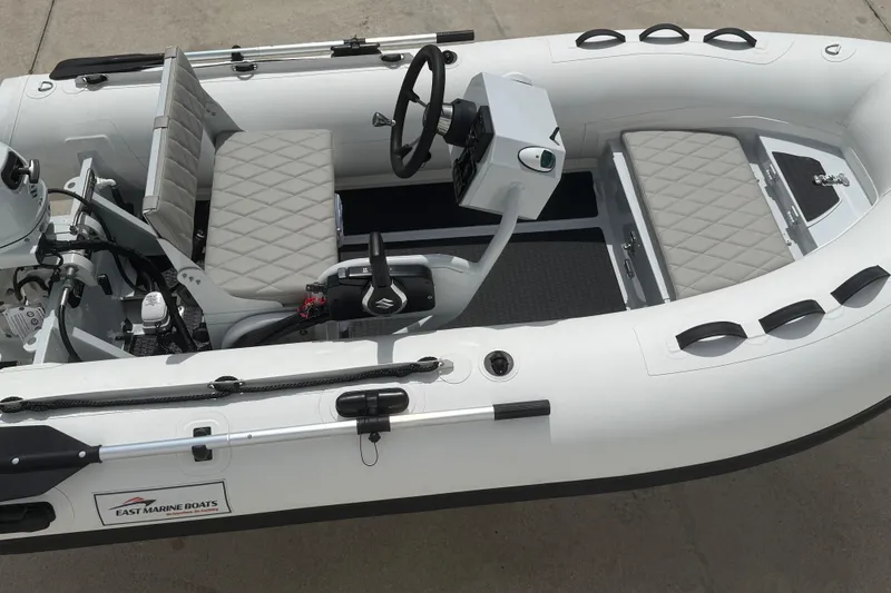 Slide: The Image of 2026 East Marine 320 inflatable boat with modern seating and steering console. - 12